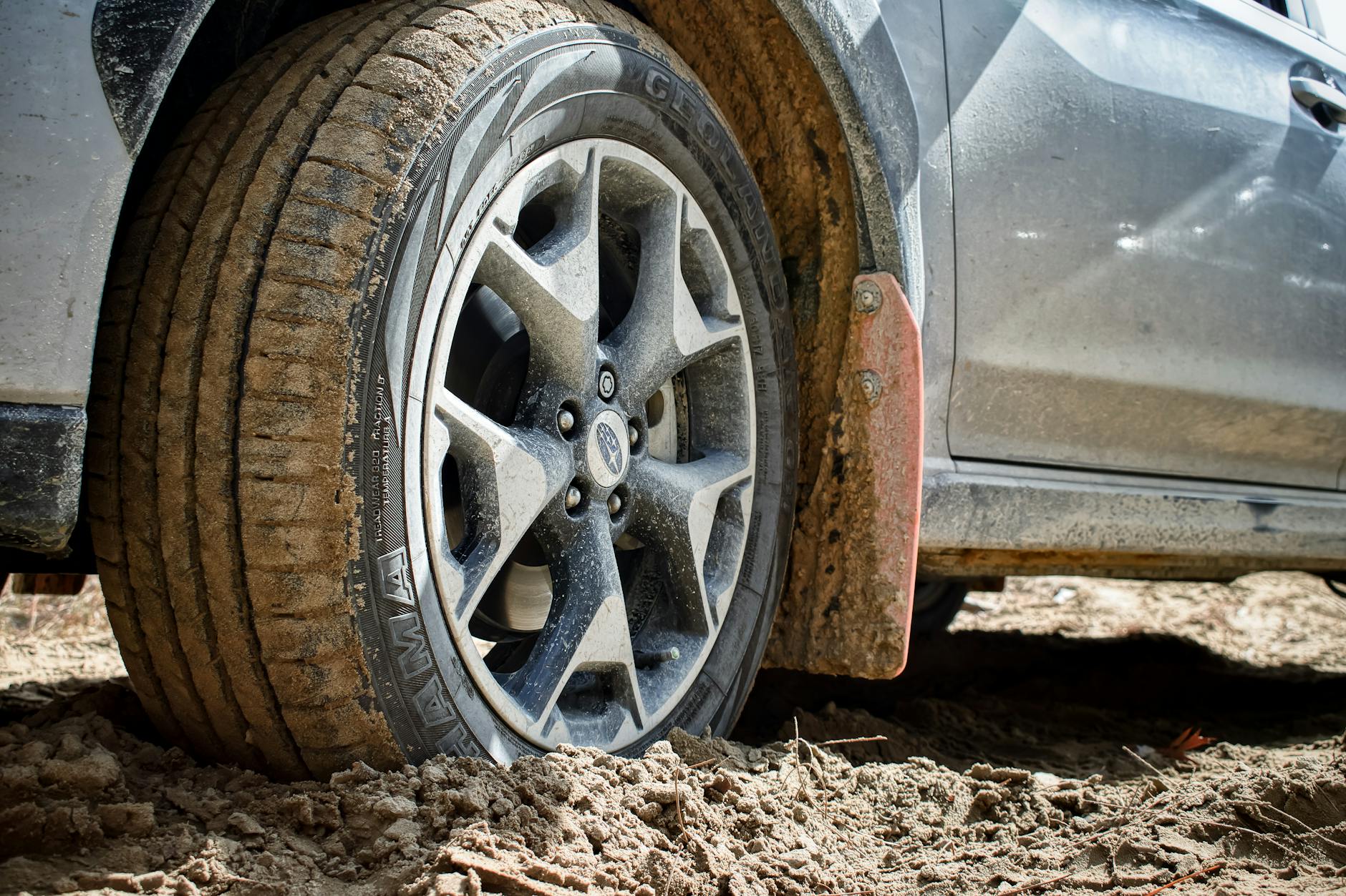 Jak dbać o napęd Subaru AWD, by nie zajechać skrzyni i dyferencjałów przed czasem Zbliżenie koła Subaru na błotnistym terenie podczas jazdy off-road